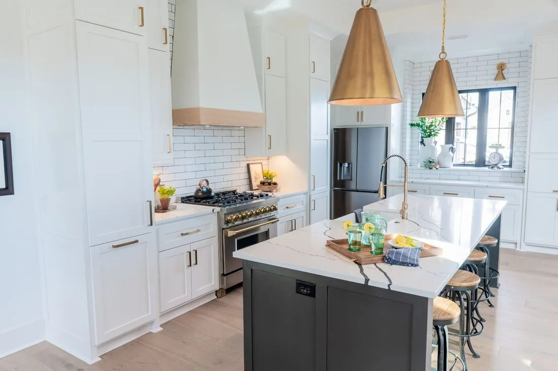 Custom white kitchen cabinets with brass pendant lighting in Chenal Valley, AR
